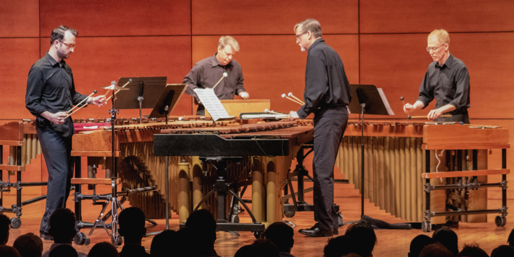 Musicians playing marimba and percussion instruments